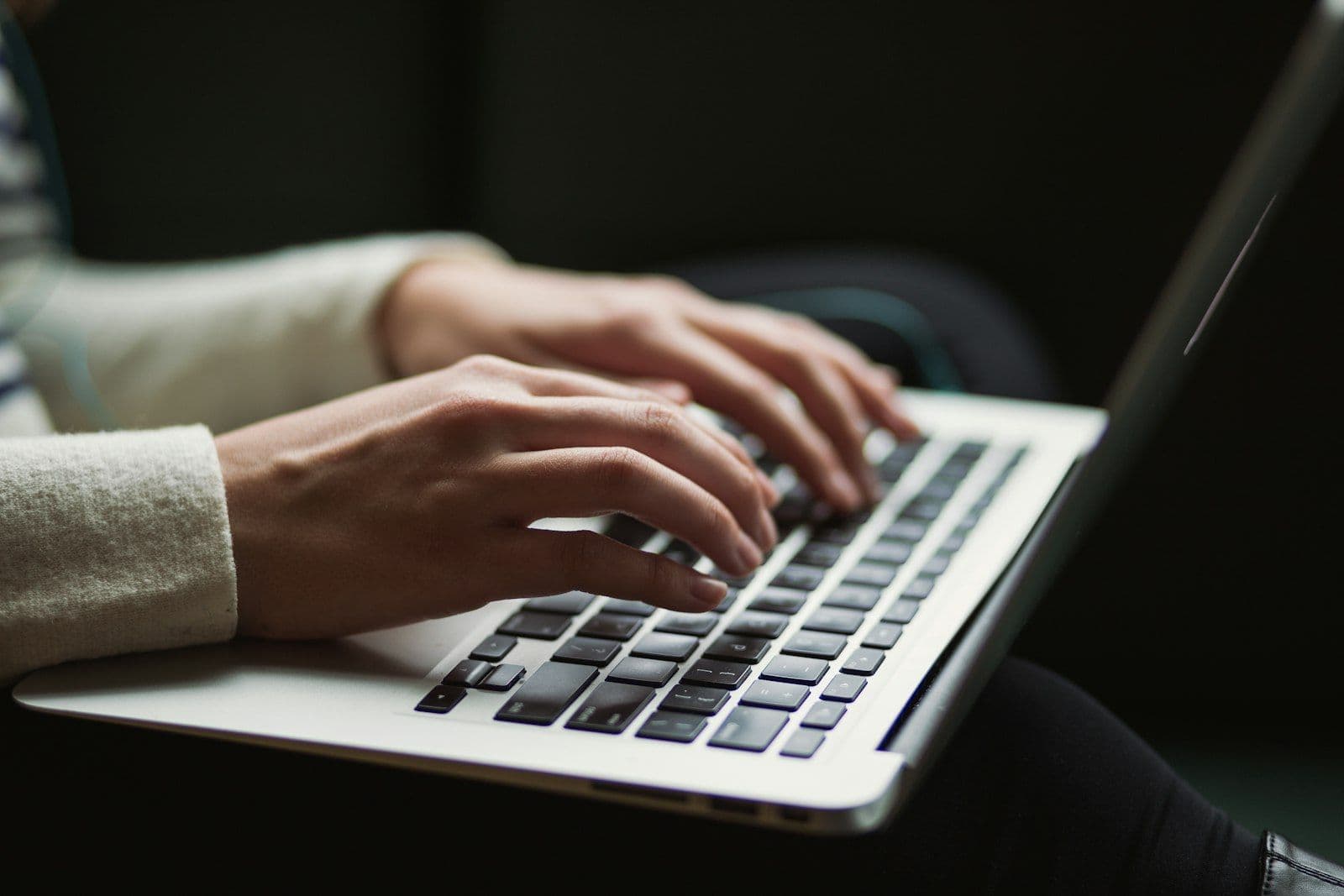 Hands typing on a laptop, illustrating online affiliate publishing and marketing